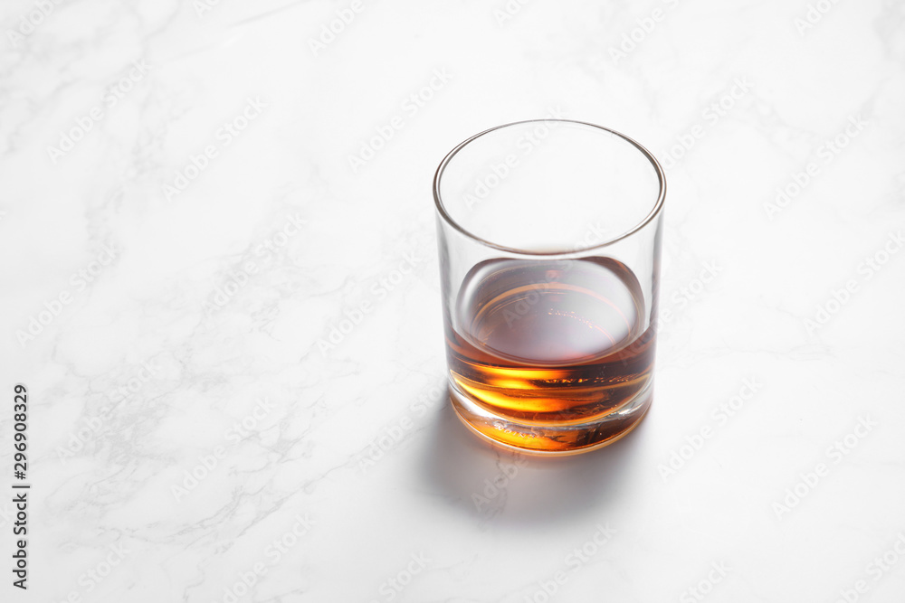 scotch whiskey in glass on a white marble table with a blank space for a text, scotch whiskey in bar background scotch whiskey in glass on a white marble table with a blank space for a text, scotch whiskey in bar background