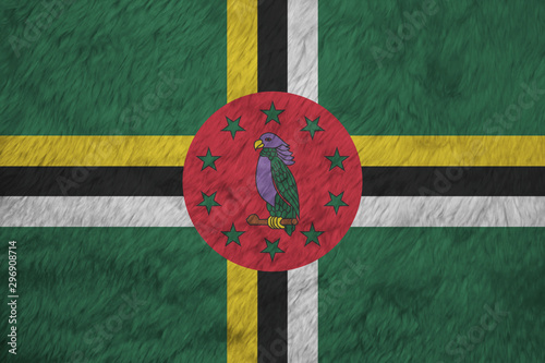 Towel fabric pattern flag of Dominica. A green field with cross of yellow black and white, Sisserou Parrot on red disk and star photo