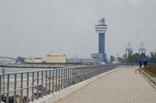 SEA COAST LANDSCAPE - Walking promenade on the background of  seaport in Gdansk photo