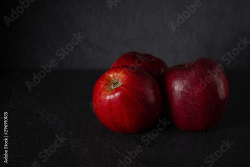 red apples against black stone background with space for text