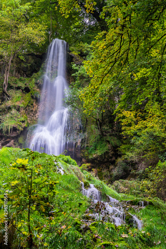 Germany  Amazing tall 37 meters high waterfall of  bad urach in climatic spa region of swabian alb nature landscape hidden in green jungle like forest  a popular tourist attraction