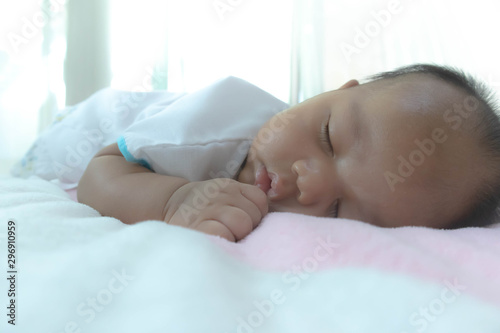 The baby's face is sleeping on a gentle bed, adequate sleep is the brain food. Allowing the body to rest Good mood, fresh and clear Create immunity