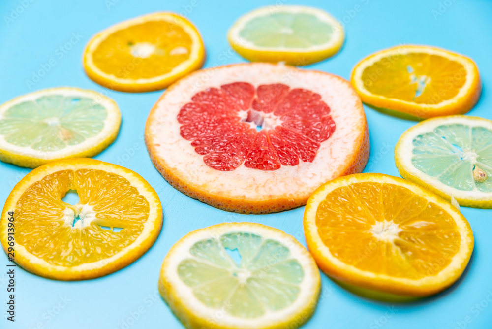 bright slices of oranges and grapefruit on a blue background bright slices of oranges and grapefruit on a blue background