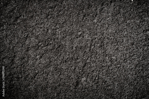 Texture of volcanic dark stone with rough surface