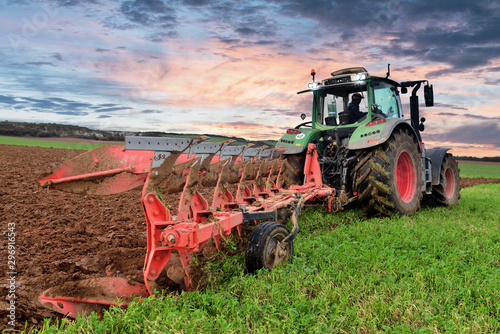 farmer plowing his fields at dusk