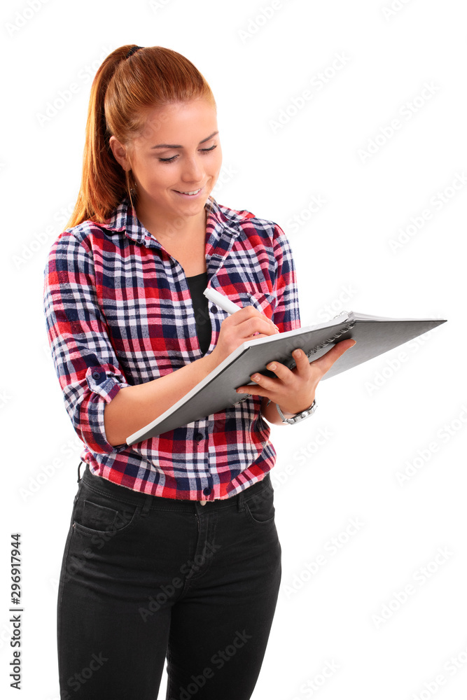 Casual smiling woman writing in a notebook Casual smiling woman writing in a notebook