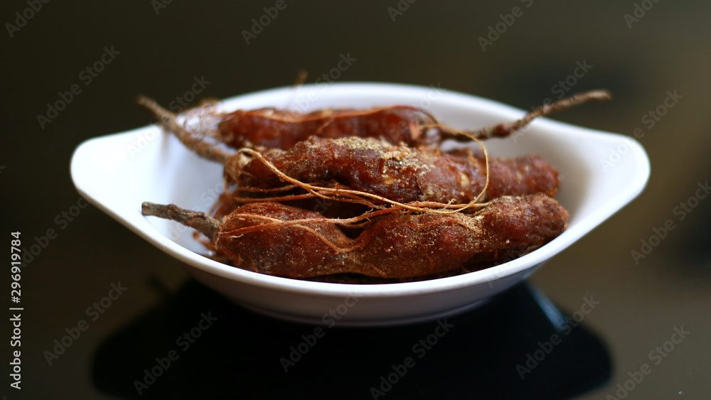 Tamarind or Tamarindus indica on black background. Tamarind or Tamarindus indica on black background.