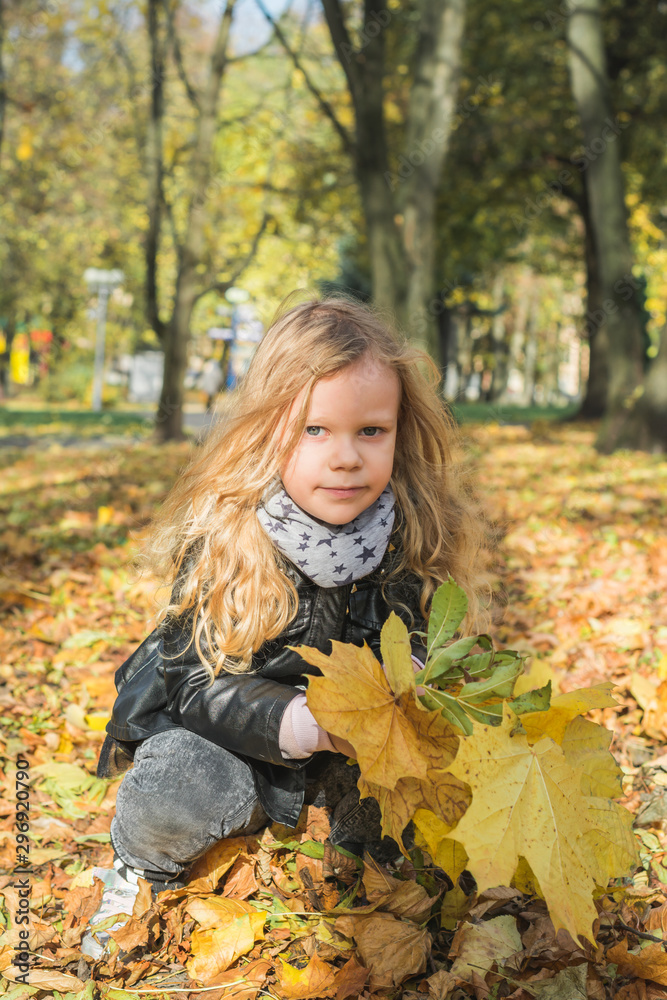 Cute five year old girl with yellow foliage Cute five year old girl with yellow foliage