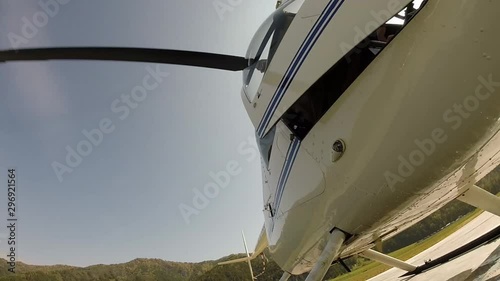 helicopter is preparing to take off, the pilot closes the door. Small lightweight aviation. bottom view on a propeller blades