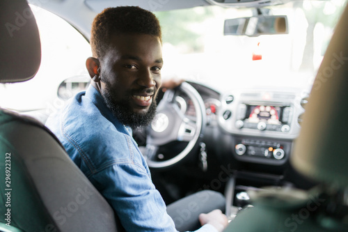Fotobehang Young african american man driving a car