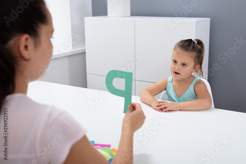 Obraz na plátně Teacher Teaching Girl To Learn Alphabet