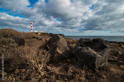 Punta Abona lighthouse. Landscape overlooking the ocean. Sunset. The water is shiny. Tenerife Island, Spain photo