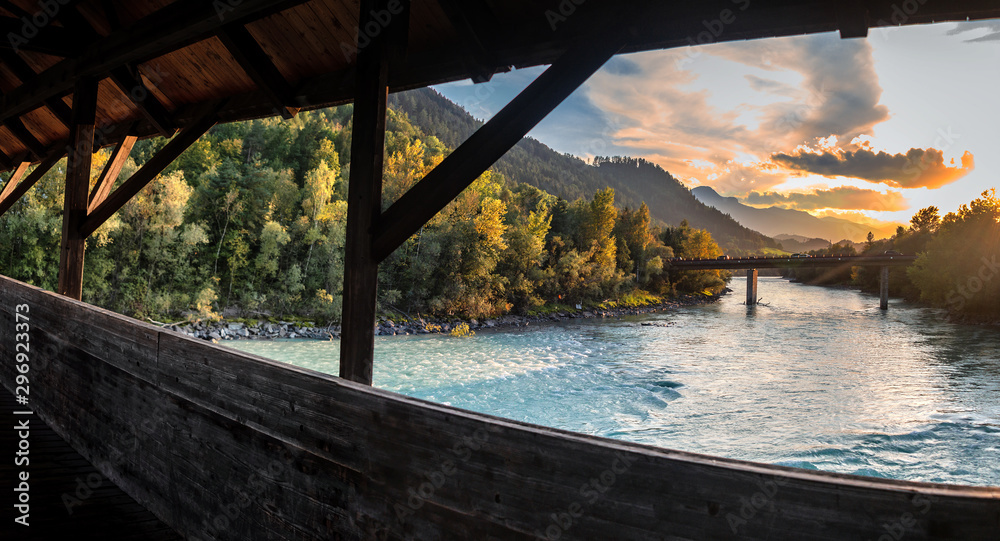 View over The Inn River In Hall in Tirol in Direction Innsbruck at sunset - obrazy, fototapety, plakaty 