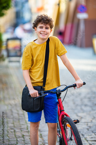 Young boy biking in city