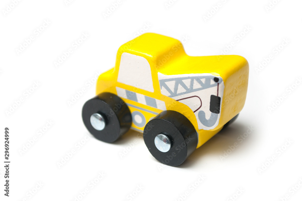 Closeup of miniature toy, wooden yellow tow truck on white background Closeup of miniature toy, wooden yellow tow truck on white background