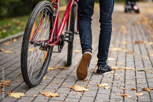 Young man biking in city park