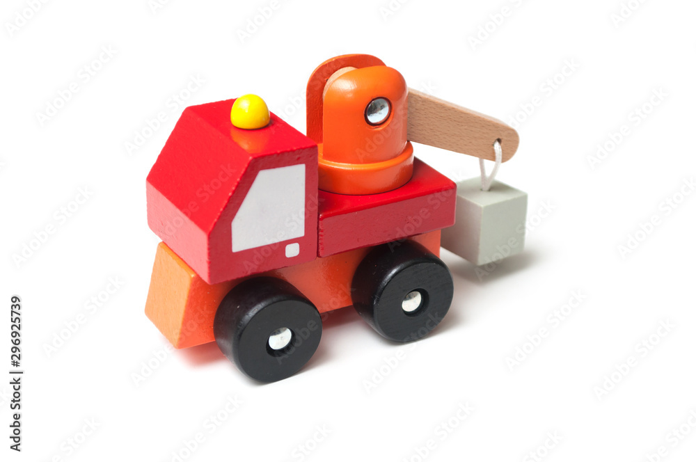 Closeup of miniature toy, wooden red truck with carrycot on white background Closeup of miniature toy, wooden red truck with carrycot on white background