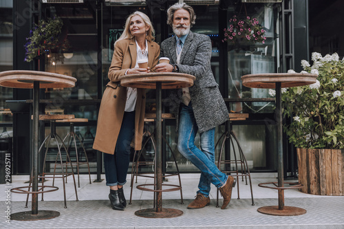 Happy adult couple enjoying coffee on the street © Yakobchuk Olena