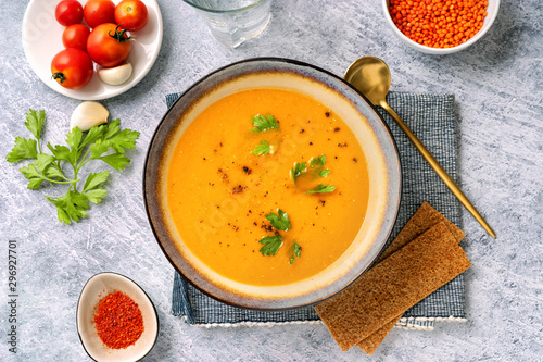 Bild auf Leinwand Winter spicy lentil cream soup on light blue background