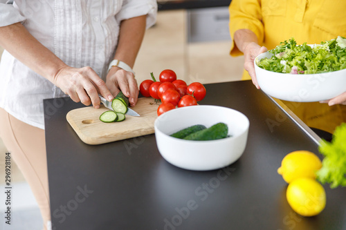 Two women is cooking together in the kitchen