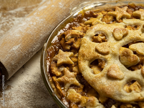 Hot apple pie with rolling pin and hearts and stars top pastry crust