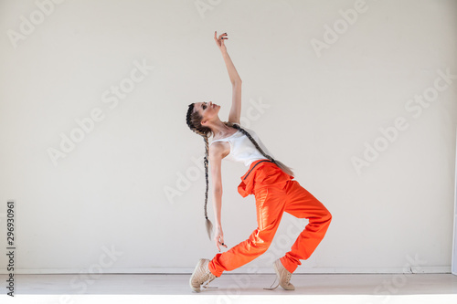 Portrait of a beautiful woman with braids dancing to music photo