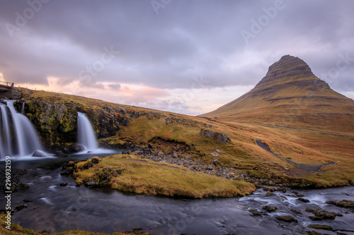 Kirkjufell mountain, Iceland. Beautiful sunset over icelandic landscape with mountain and waterfalls