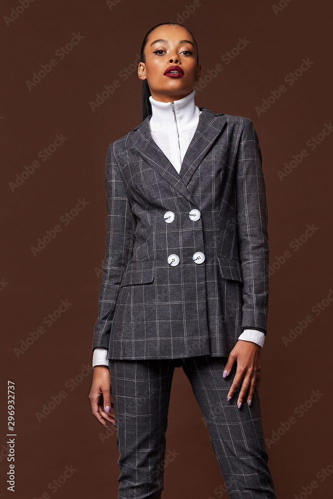 Fototapeta premium Sexy beautiful woman fashion glamour model brunette hair makeup wear suit trousers jacket clothes office dress code casual party style accessory date walk girl skinny body shape studio tanned skin.