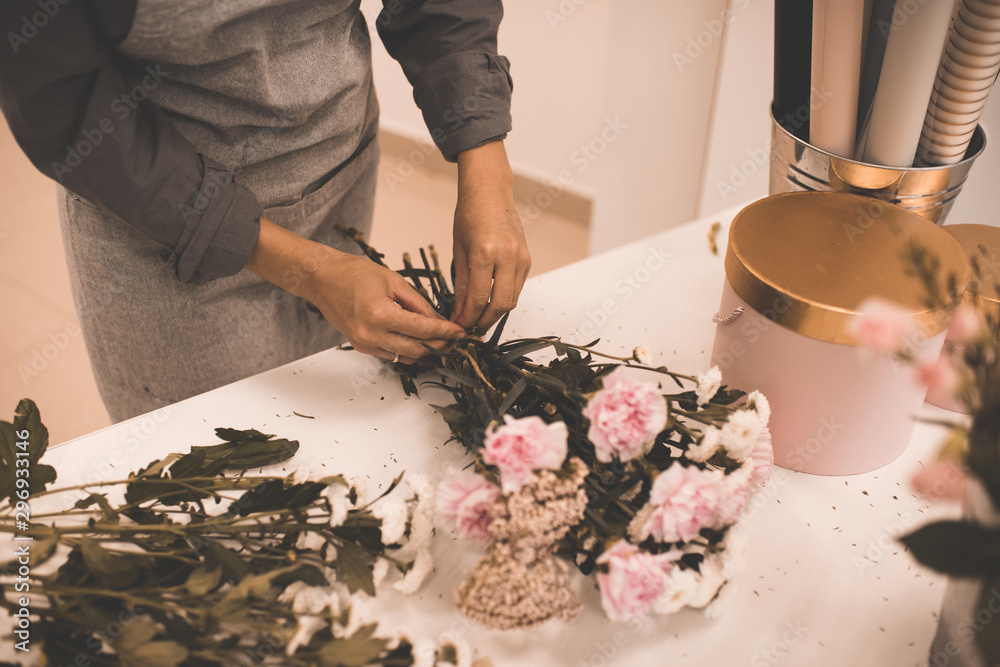 Woman making flower bouquet in room closeup. Woman making flower bouquet in room closeup.