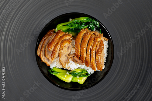 Roast Duck with rice and vegetable in black plate