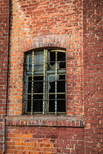Broken window of an old brick building