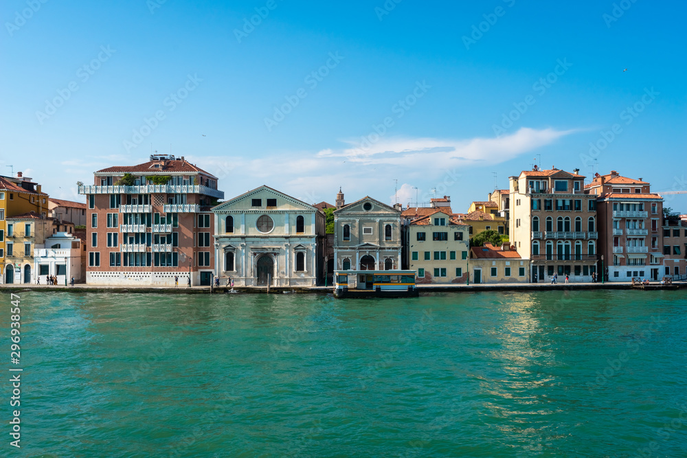 Venice. Vacation in Italy. Panoramic view of Venice from the Grand Canal. Venetian old colorful buildings on blue sky background. Boat trip through the canals of Venice. Travel, Tourism, Holidays.
