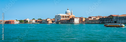 Venice. Vacation in Italy. Panoramic view of Venice from the Grand Canal. Venetian old colorful buildings on blue sky background. Boat trip through the canals. Header. Banner.