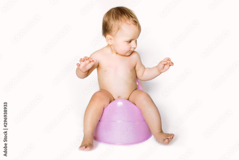 Little toddler baby kid girl sitting on plastic potty on a white background Little toddler baby kid girl sitting on plastic potty on a white background