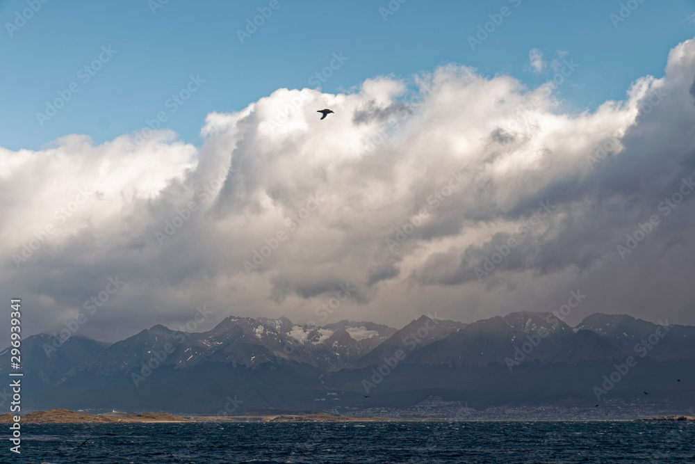 Argentina, Patagonia – ocean shore with mountains in the background.