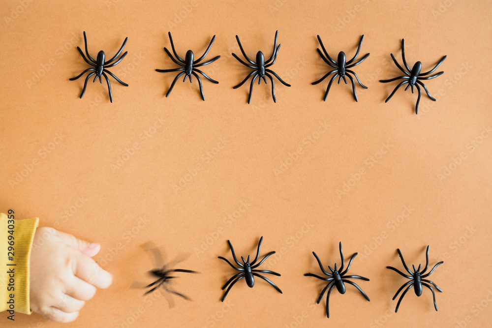 Halloween background decoration holiday concept. Minimal flat lay view of black spide. October Halloween background decoration holiday concept. Minimal flat lay view of black spide. October