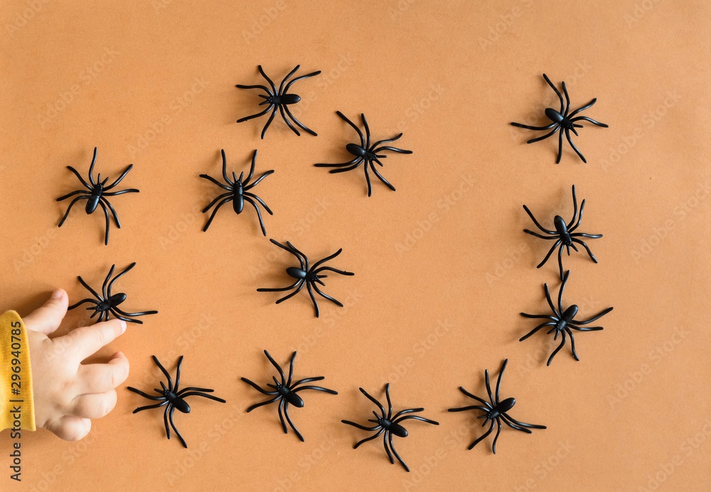 Halloween background decoration holiday concept. Minimal flat lay view of black spide. October Halloween background decoration holiday concept. Minimal flat lay view of black spide. October