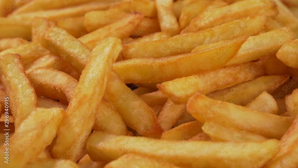 Delicious french fries close up - camera slide, top view Delicious french fries close up - camera slide, top view