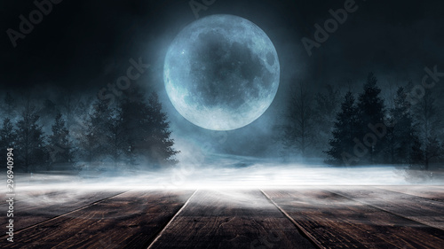 Dark forest. Gloomy dark scene with trees, big moon, moonlight. Smoke, shadow. Abstract dark, cold street background. Night view. Night wooden table