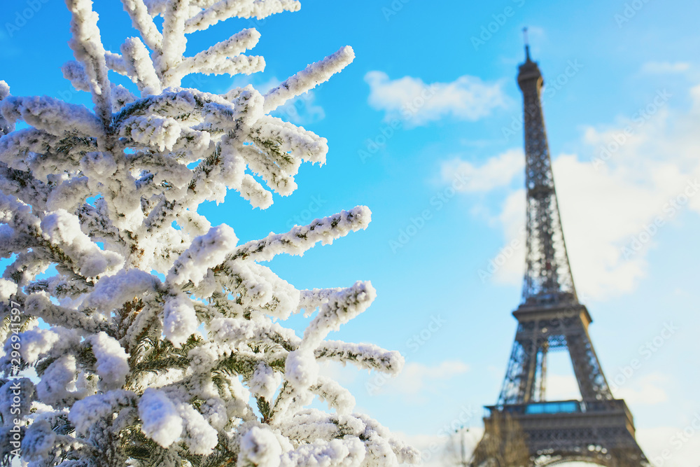 Christmas tree covered with snow near the Eiffel tower