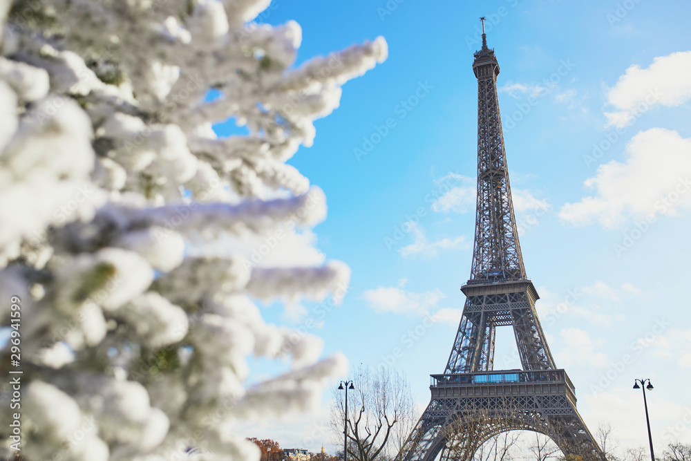Christmas tree covered with snow near the Eiffel tower