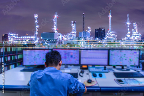 Engineering works with the tablet in the production control room.Control room of a steam Turbine,Generators of Oil refinery industry plant for monitor process, business and industry concept 