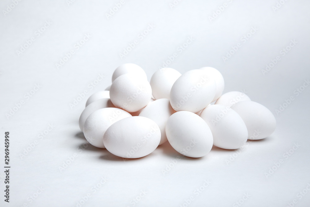 heap of white chicken eggs on a white background heap of white chicken eggs on a white background
