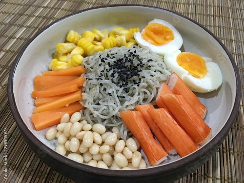 ิBlack sesame noodle with crab strick, boiled egg, white kidney beans, carrot and corn photo