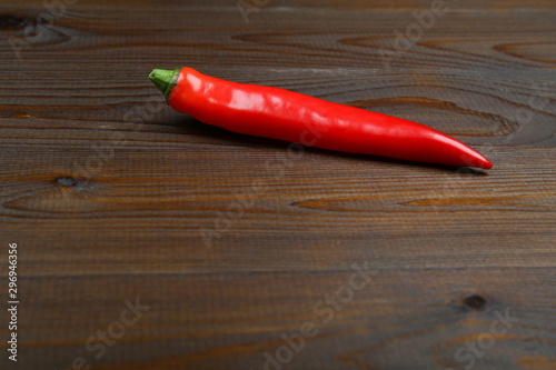 red hot chili pepper on a dark board with copy space