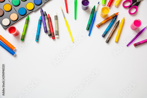Colorful paints on white color background, top view