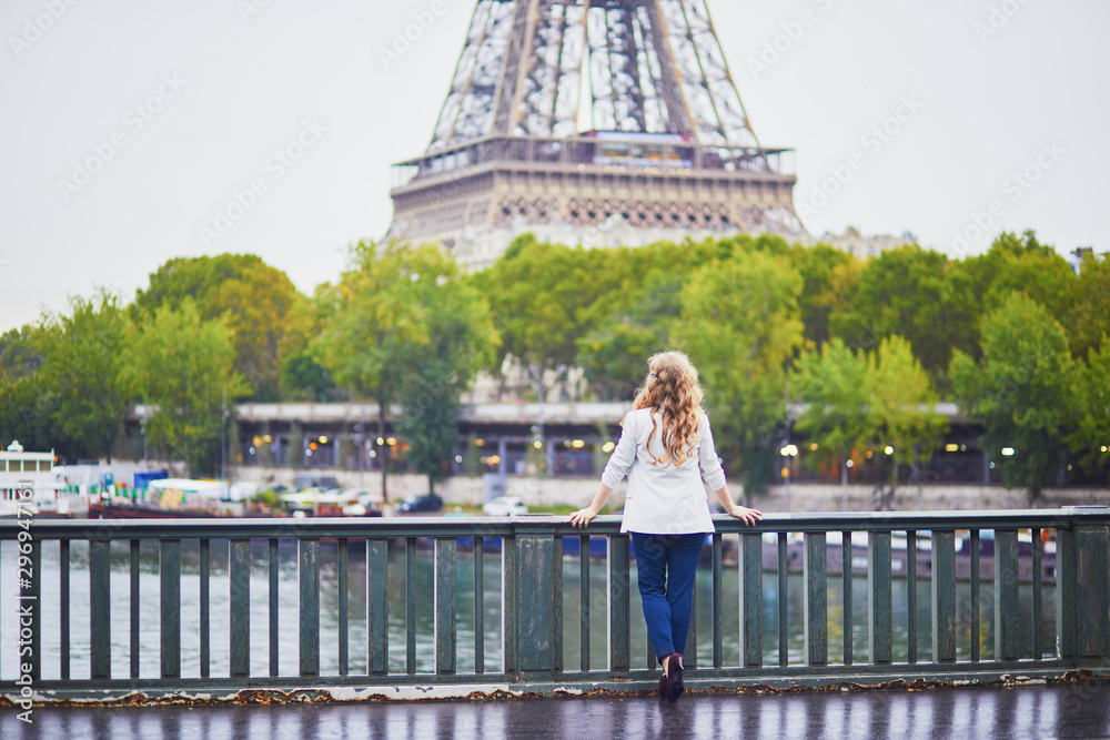 Young woman with long blond curly hair in Paris, France