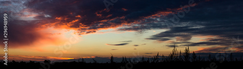 Panorama of the sunset. Beautiful sunset. Sky and clouds on the sunset.
