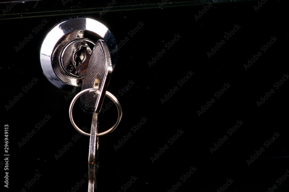 silver key on a cash box in the lock silver key on a cash box in the lock