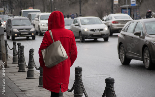 The lady in red on a gray city background photo